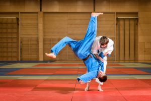 young judokas fighting in dojo